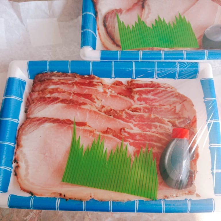 青と白のトレイに入った焼き豚とタレ